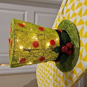 Mad Hatter tree topper that lights up. Green, with red polka dots.